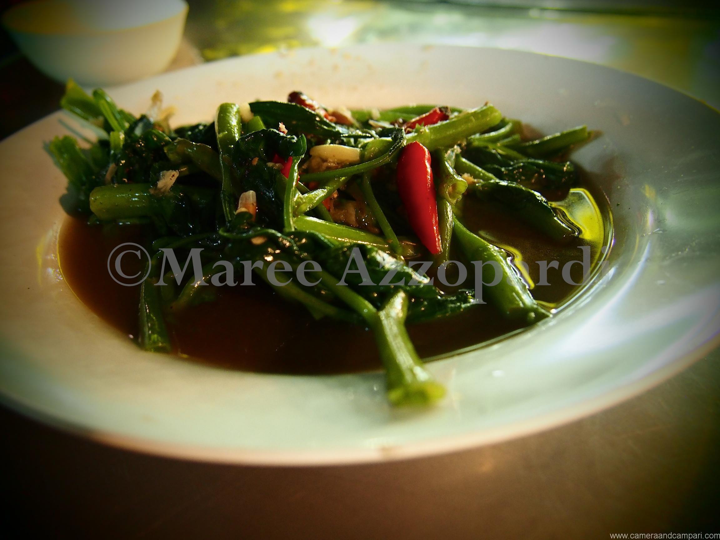 A plate of chilli fried morning glory (water spinach).